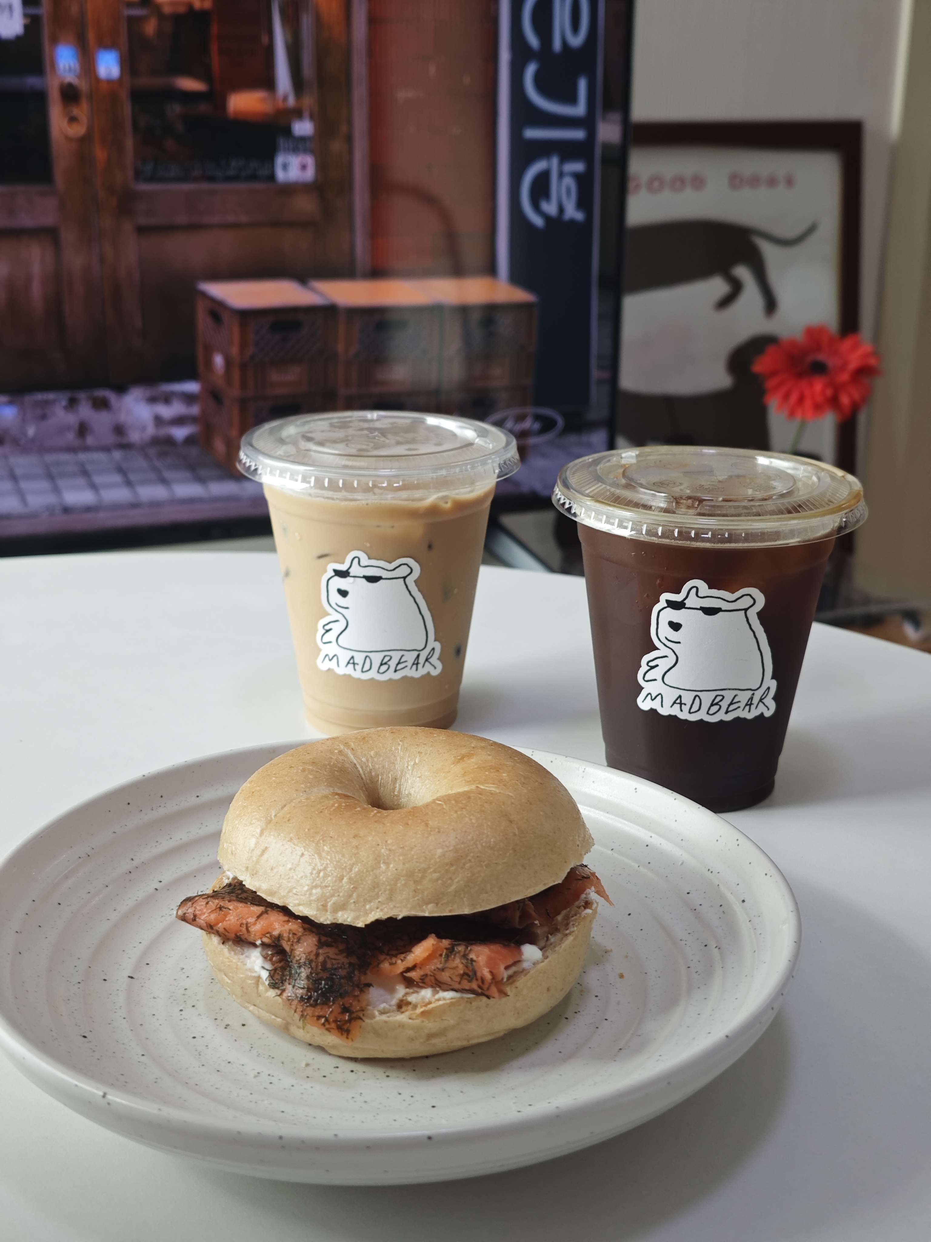 Two iced Madbear coffees with a bagel